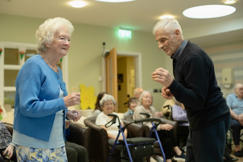 two older adults dancing together