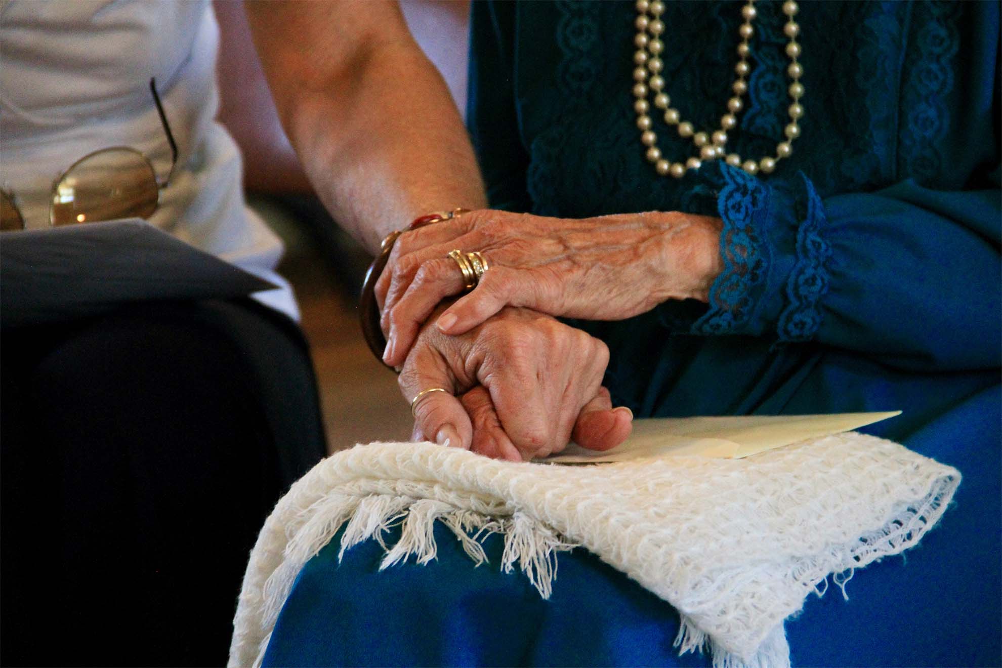 holding hands to comfort resident