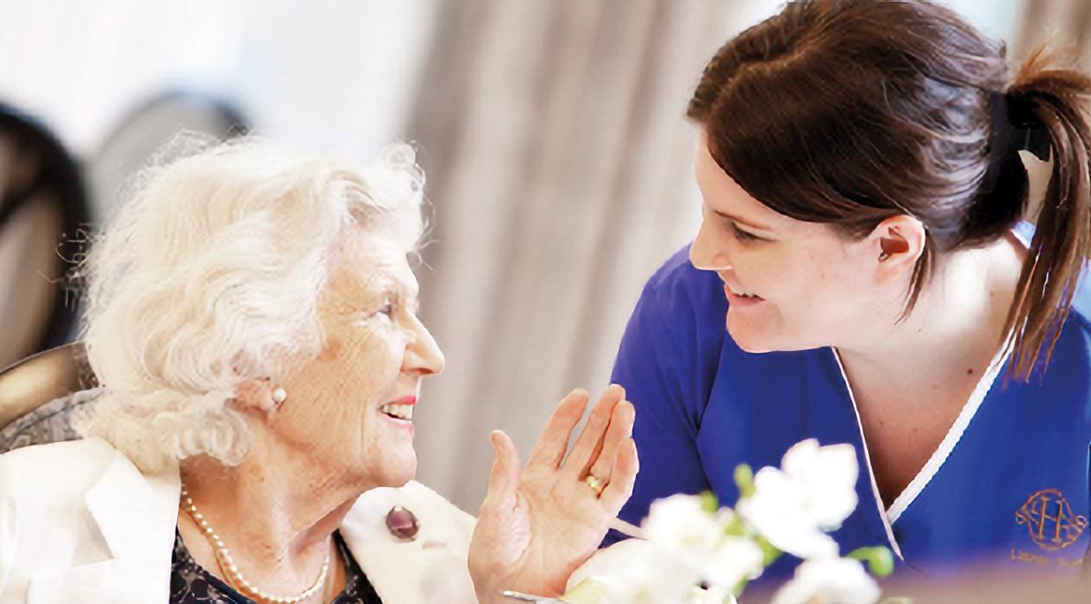 care home resident smiling with carer