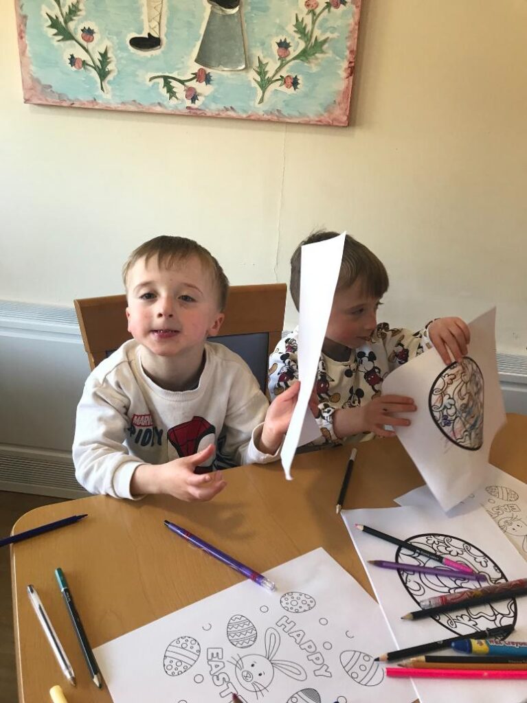 kids colouring at a table
