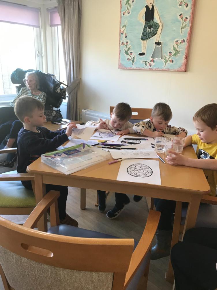 kids sat around a table colouring