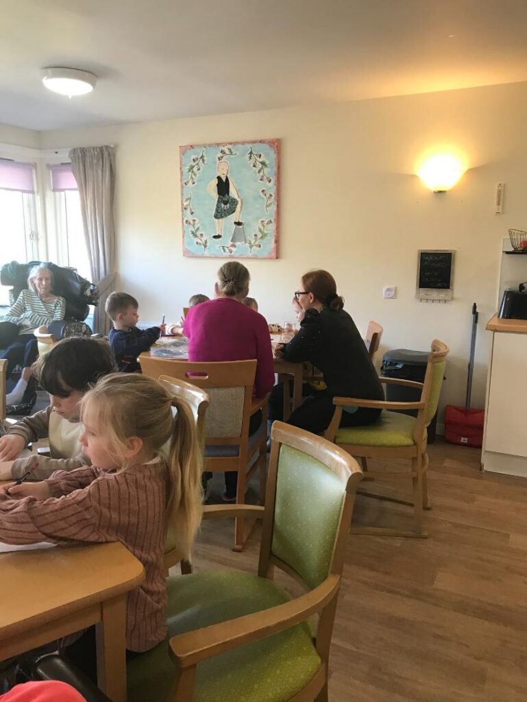 adults and children sat around a children